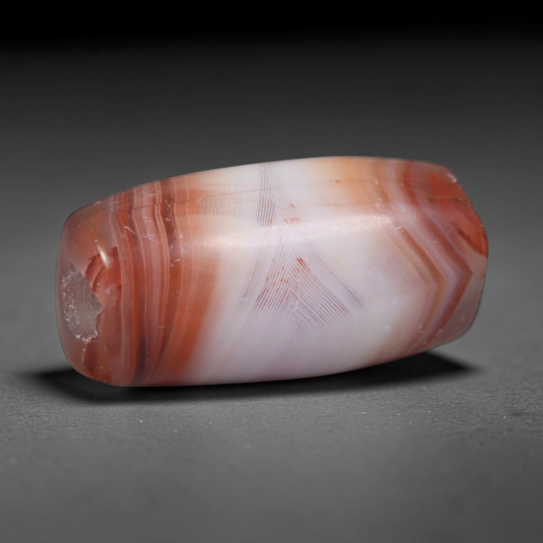 Ancient Indus Valley / Harappan Civilization Banded Agate Barrel Bead (2600-1900 BCE), 22AD: This antique banded agate barrel bead originates from the Indus Valley / Harappan Civilization, the pioneering ancient South Asian culture that mastered precision drilling, heat treatment and fine ban