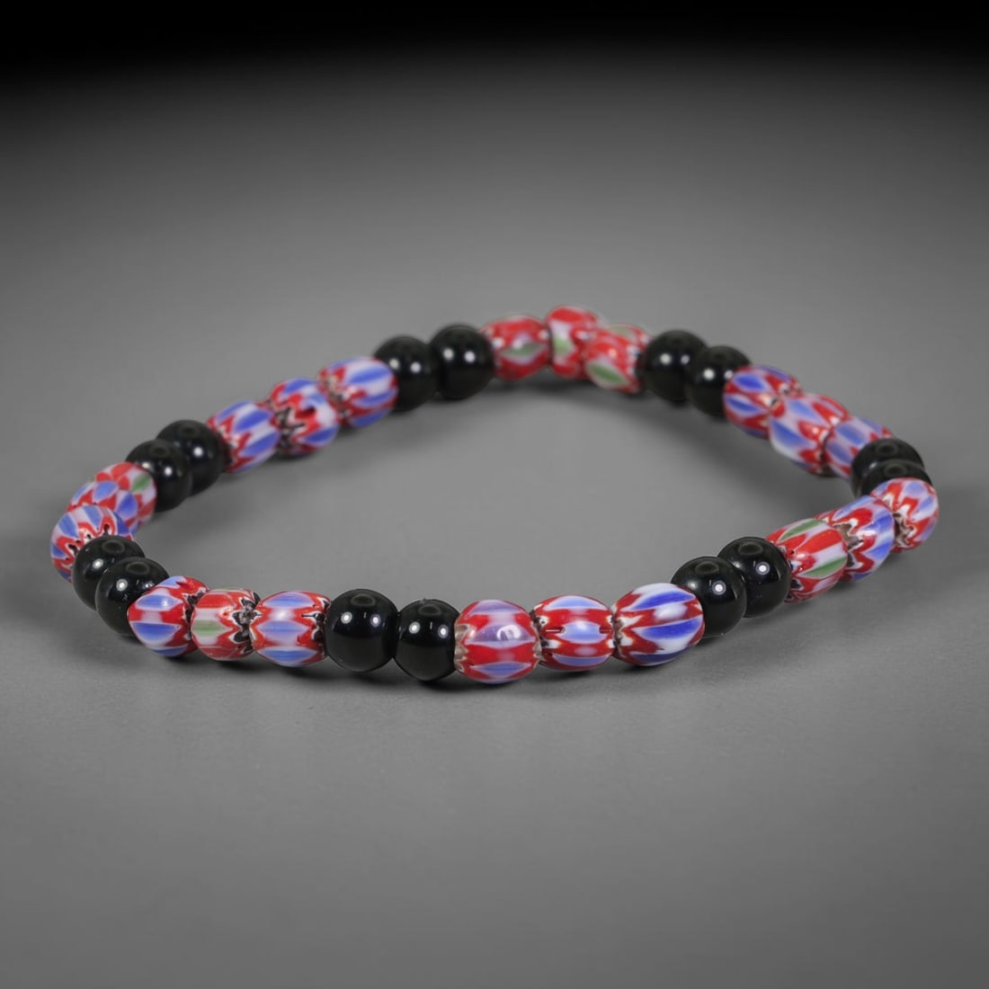 Vintage Millefiori Chevron Mixed-Glass Bead Bracelet, 52EK: Eye-catching strand combining millefiori patterned glass beads alongside smooth solid black glass beads. Bead size measures 6.5mm. Flexible wearable bracelet well-suited for everyday wear and glass-be