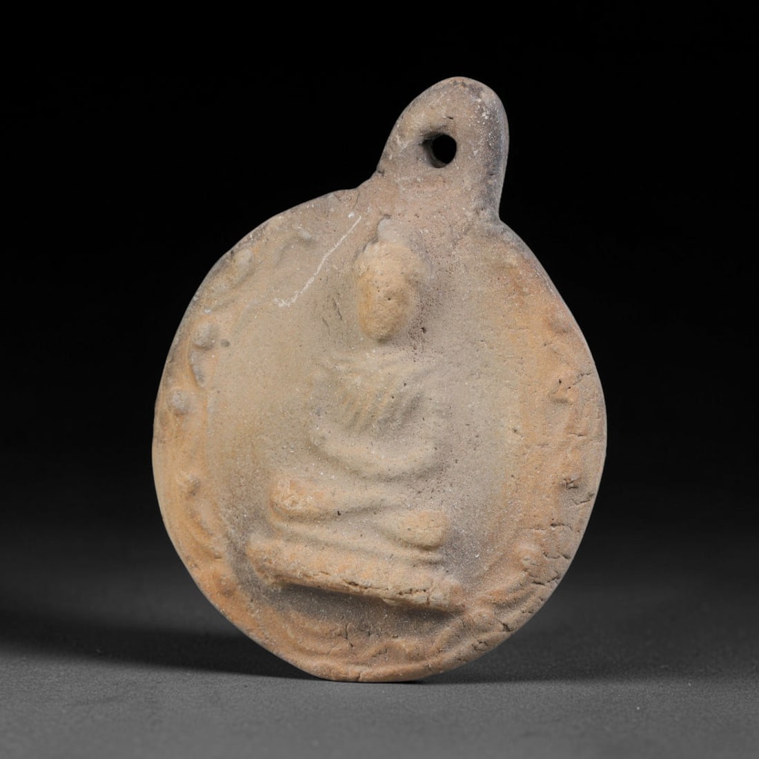 Ancient Gandhara Terracotta Buddhist Plaque (100 BCE-400 CE), 41EK: This ancient terracotta pendant plaque originates from Gandhara, a major centre of early Buddhist art along the Silk Road, shaped as a wearable devotional amulet with an integral suspension hole. The 