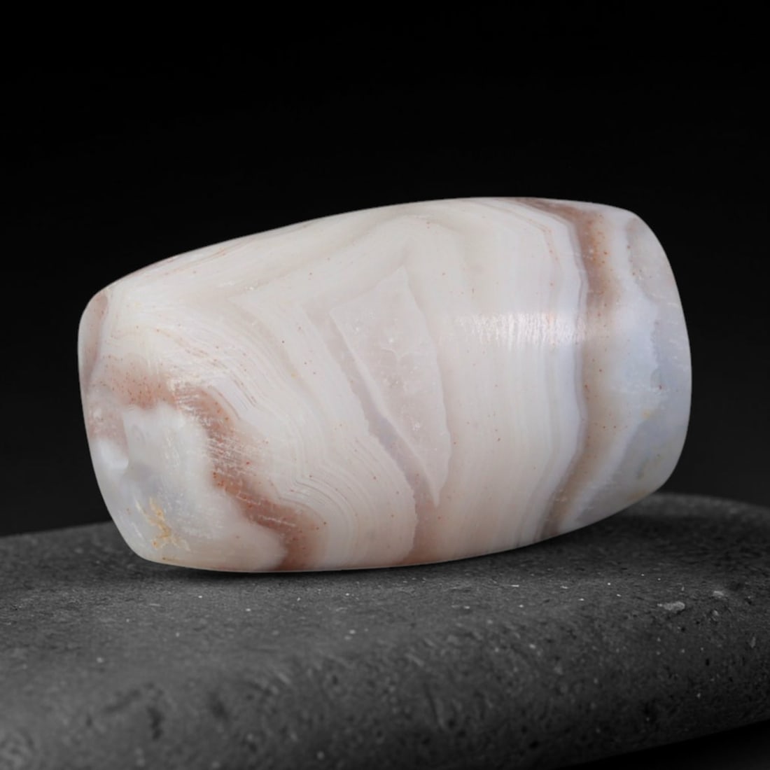 Ancient Neo-Assyrian Empire Banded Agate Barrel Bead (911-609 BCE), 99AD: This antique banded agate barrel bead originates from the Neo-Assyrian Empire, a dominant Iron Age Mesopotamian power with refined lapidary workshops producing ritual talismans, royal regalia and elit