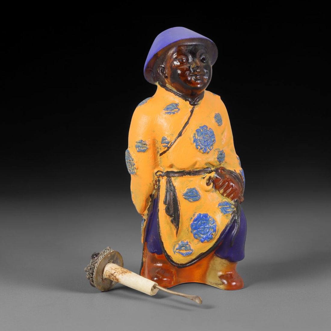 Vintage Chinese Liuli Glass Snuff Bottle - Standing Robed Attendant, 51AS: This snuff bottle is moulded from translucent amber liuli glass and formed as a standing attendant figure. The traditional robe is decorated with hand-painted blue floral roundels against an orange gr