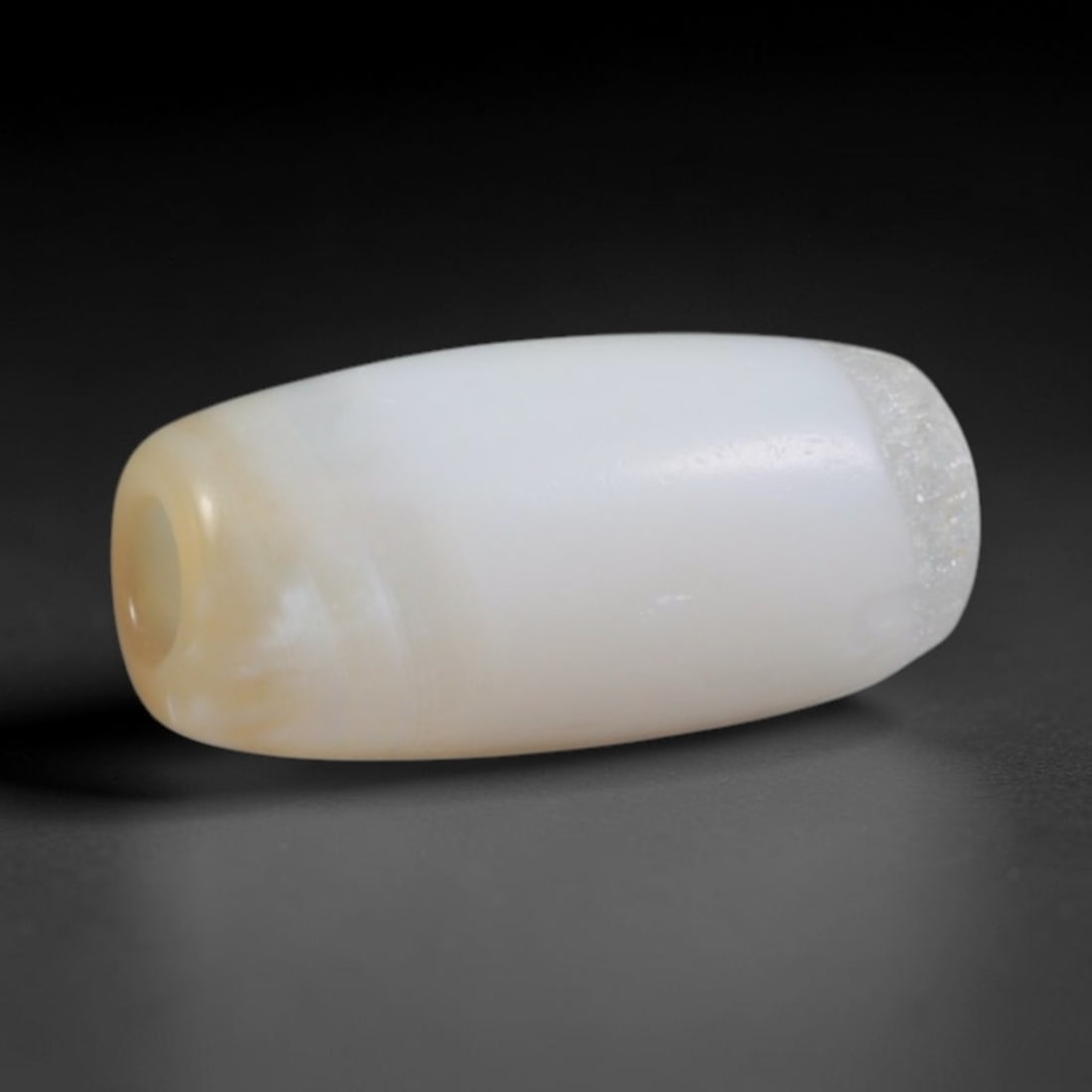 Ancient Early Islamic Near Eastern Banded Agate Barrel Bead (7th-12th CE), 9AD: This antique banded agate barrel bead originates from Early Islamic Near Eastern lapidary workshops, which preserved and refined Sassanian chalcedony carving techniques to craft minimalist agate beads