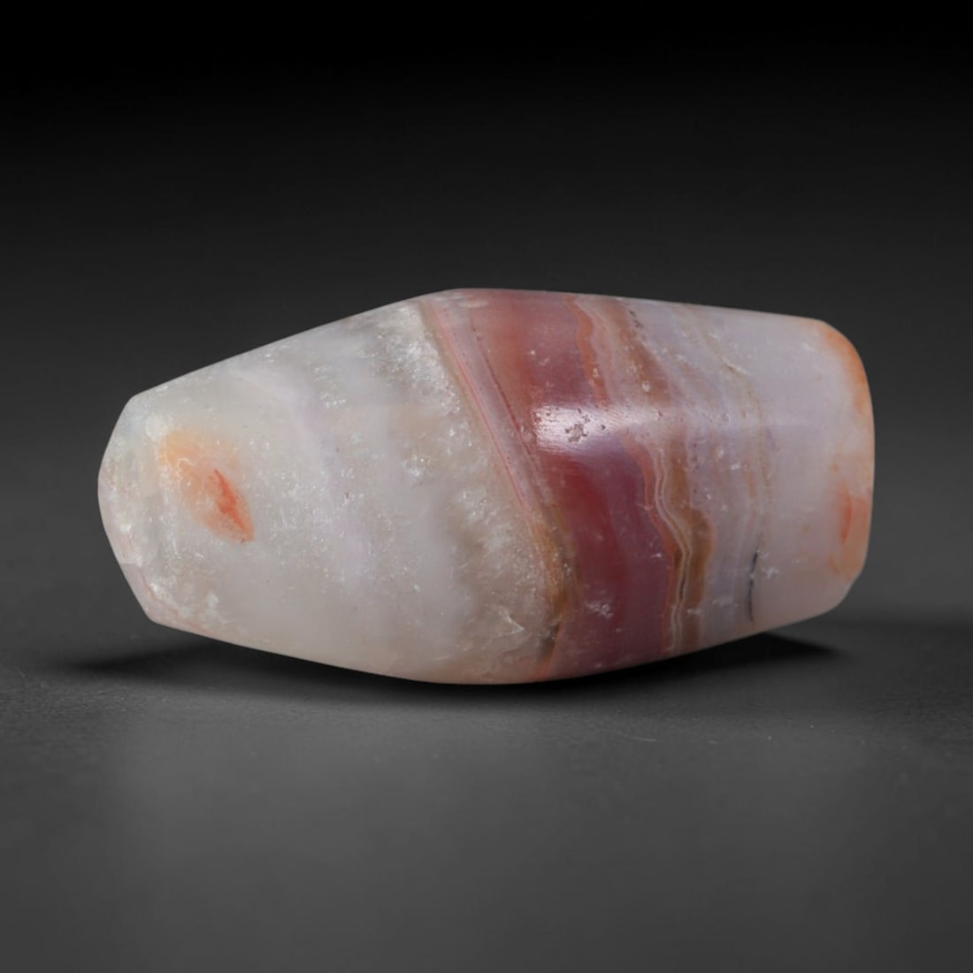Ancient Neo-Hittite / Anatolian Bronze Age Cultures Banded Agate Barrel Bead (2000-700 BCE), 44AD: This antique banded agate barrel bead originates from Neo-Hittite / Anatolian Bronze Age Cultures, regional Anatolian stone crafters that produced distinct agate bead wares reserved for elite burial g