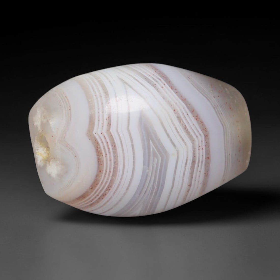 Ancient Mughal Cambay Gujarat Banded Agate Barrel Bead (1526-1800 CE), 23AD: This antique banded agate barrel bead originates from the historic Cambay bead workshops under Mughal rule, the primary Indian production hub for fine banded chalcedony traded via Indian Ocean and ove