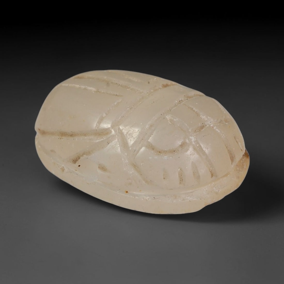 Ancient Pharaonic Egyptian Agate Scarab Amulet Bead (3100 BCE-30 CE), 41EC: This antique scarab amulet bead is carved from natural agate, originating from Pharaonic Egyptian culture. Scarabs were sacred protective talismans closely linked to rebirth and eternal life within an