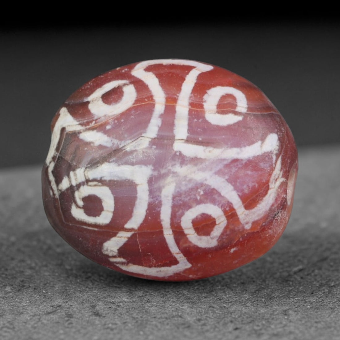 Antique Sino-Himalayan Region Etched Carnelian Bead, 17EH: Antique etched carnelian bead originating from the Sino-Himalayan region. Exhibits characteristic surface patina and traditional etched white decoration. Dimensions: 14x12mm, fully pierced for suspens