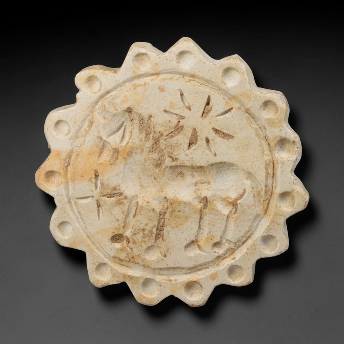 Ancient Neo-Hittite Sunburst Form Limestone Stamp Seal (1200-800 BCE), 20EF: This ancient multi-lobed sunburst stamp seal is carved from pale limestone, originating from Neo-Hittite Syro-Anatolian cultures of Iron Age Northern Syria and Eastern Anatolia, famed for distinctive 