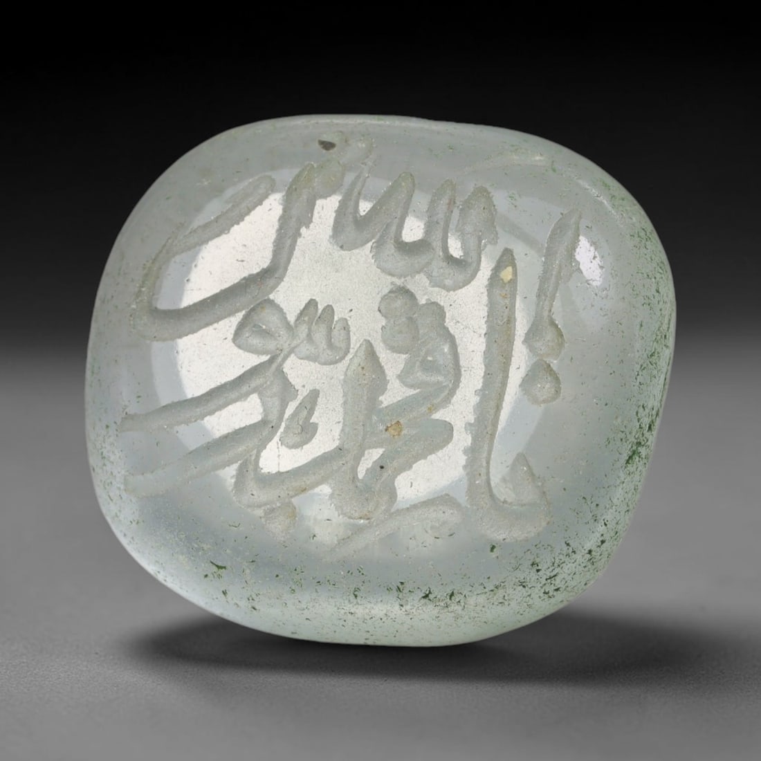 Early Vintage Islamic White Glass Calligraphic Script Intaglio Seal Cabochon (Post 1900 CE), 96BX: This early vintage glass intaglio seal cabochon draws from enduring Islamic seal-making traditions, formed from translucent pale glass with a smoothly rounded polished surface. The face features caref