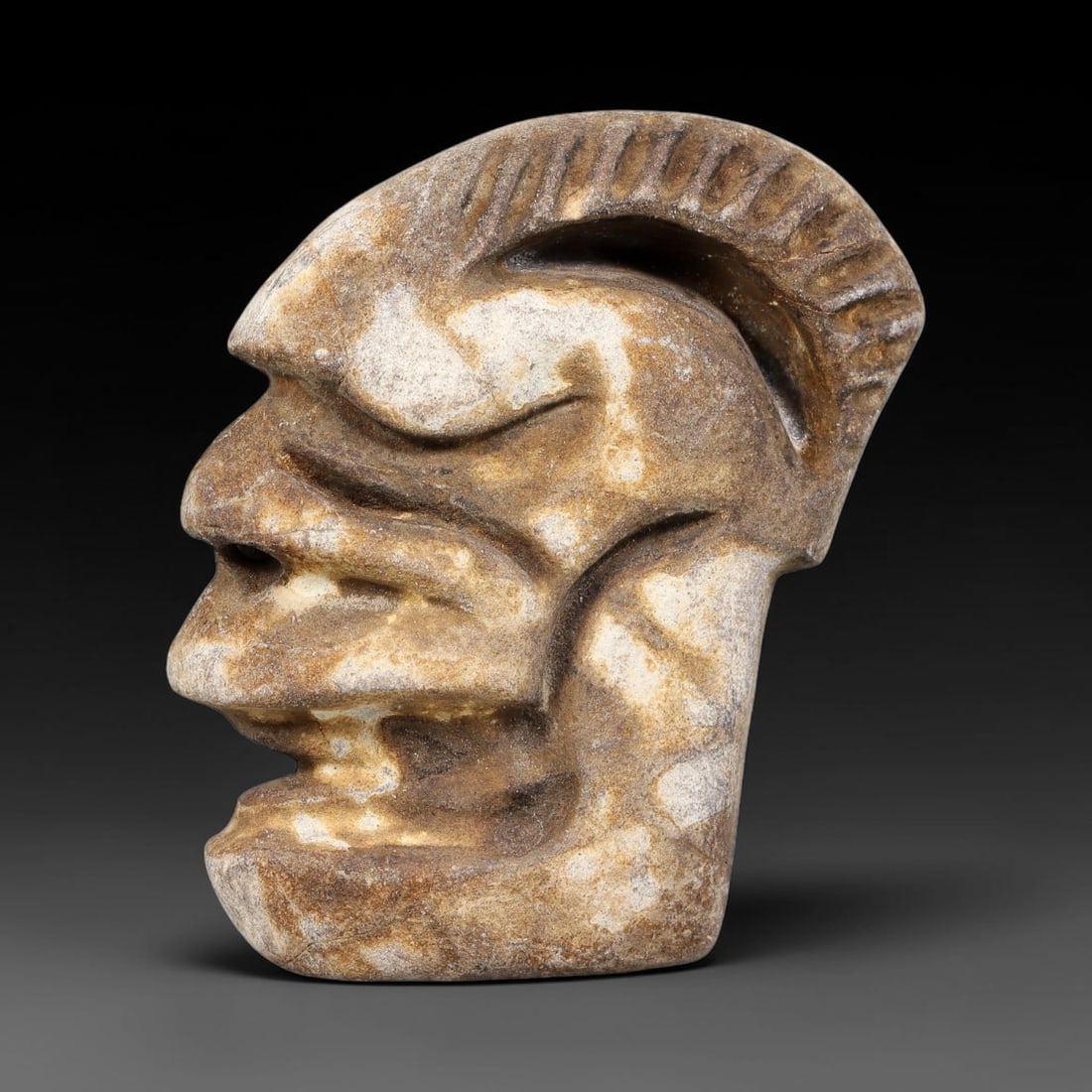Ancient Medieval Near Eastern Stone Maskette (500-1000 CE), 68EJ: This antique stone maskette originates from medieval Near Eastern cultural tradition, produced for ceremonial and talismanic purposes. The stone shows natural earthy discoloration, surface weathering 