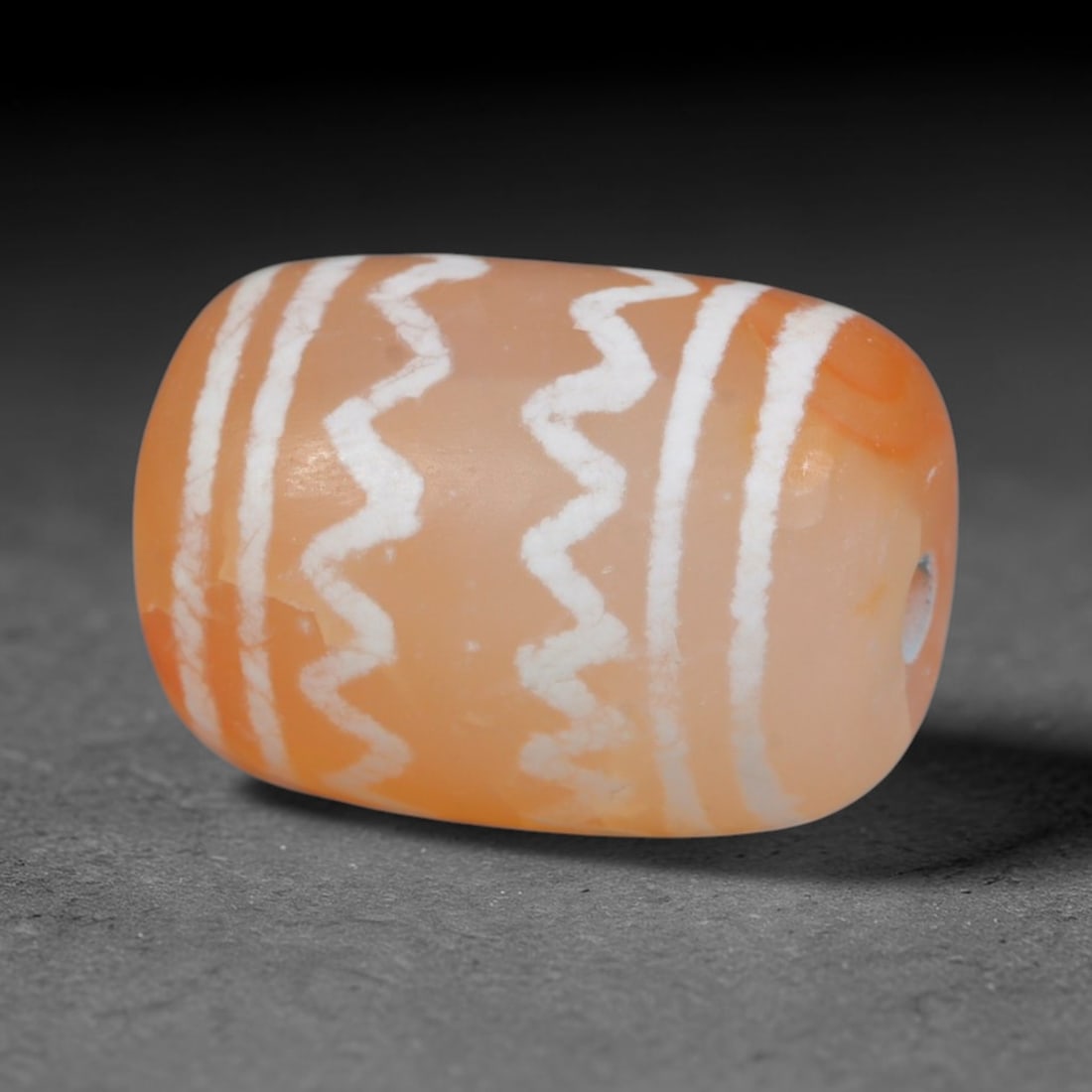 Antique Sino-Himalayan Region Etched Carnelian Bead, 19EH: Antique etched carnelian bead originating from the Sino-Himalayan region. Exhibits characteristic surface patina and traditional etched white decoration. Dimensions: 15x11mm, fully pierced for suspens