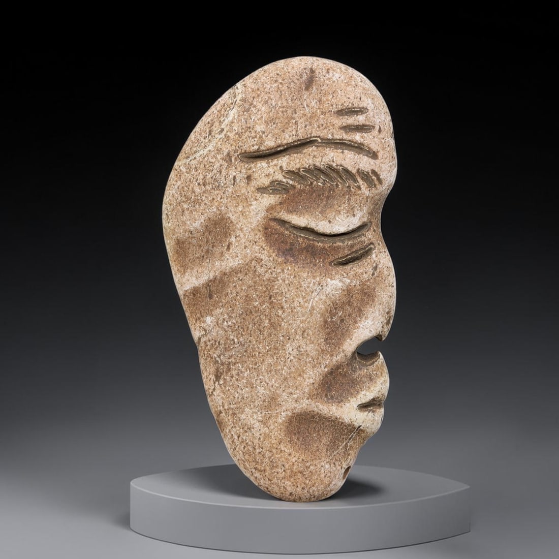 Ancient Medieval Near Eastern Stone Maskette (500-1000 CE), 66EJ: This antique stone maskette originates from medieval Near Eastern cultural tradition, produced for ceremonial and talismanic purposes. The stone shows natural earthy discoloration, surface weathering 