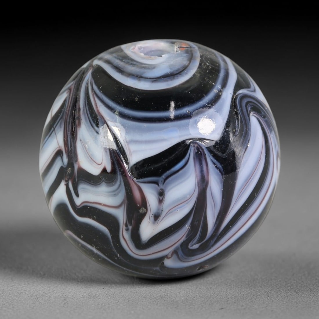 Swirled Dark Tone Blown Glass Bead - Handmade Vintage Spherical Ornament, 21AE: This spherical bead is formed via hand-blown glass techniques, featuring fluid marbled swirl layers of black, pale lavender white, and thin burgundy streaks that curve continuously across the polished