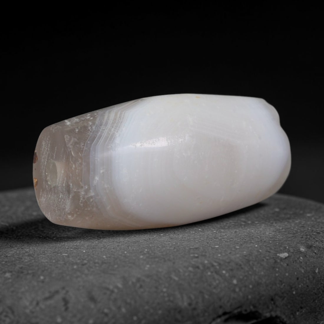 Ancient Early Central Asian Steppe anded Pale Taupe Agate Barrel Bead (500-100 BCE), 83AD: This compact banded agate barrel bead originates from the early nomadic steppe cultures of Central Asia, communities with a long legacy of carving natural banded agate into protective talisman ornamen