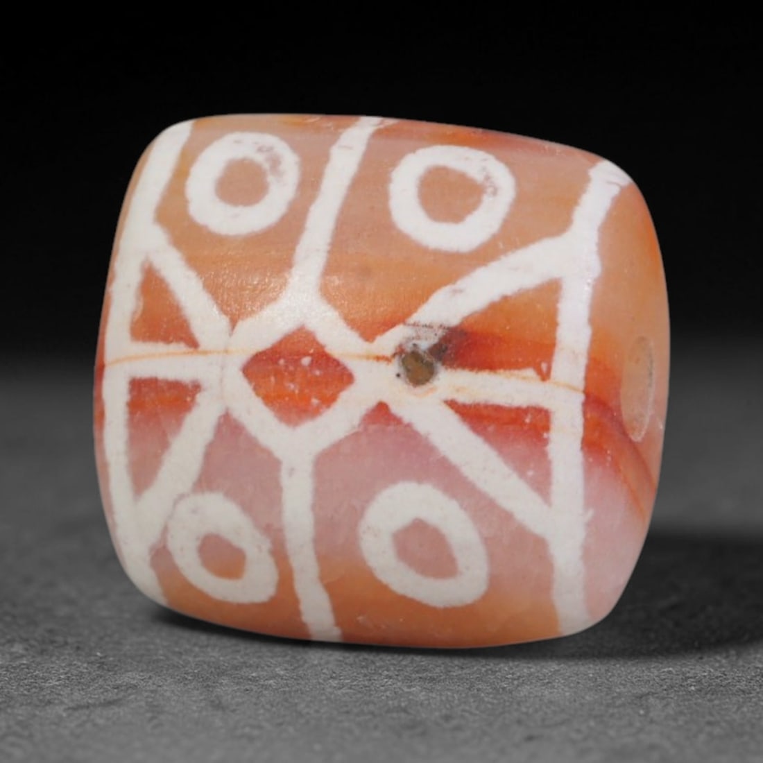 Antique Sino-Himalayan Region Etched Carnelian Bead, 4EH: Antique etched carnelian bead originating from the Sino-Himalayan region. Exhibits characteristic surface patina and traditional etched white decoration. Dimensions: 12x11mm, fully pierced for suspens