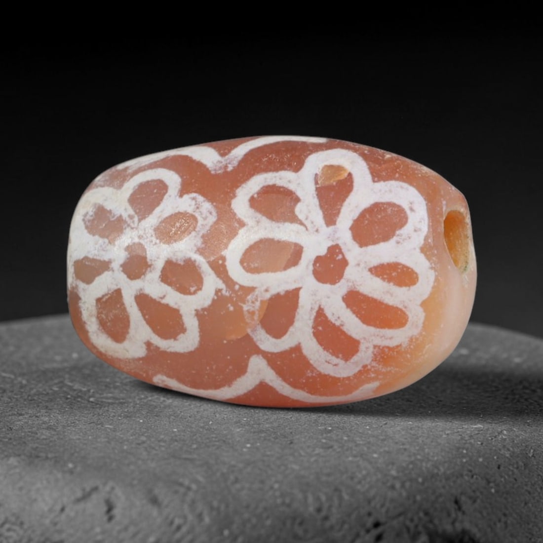 Antique Sino-Himalayan Region Etched Carnelian Bead, 79EG: Antique etched carnelian bead originating from the Sino-Himalayan region. Exhibits characteristic surface patina and traditional etched white decoration. Dimensions: 11x9mm, fully pierced for suspensi
