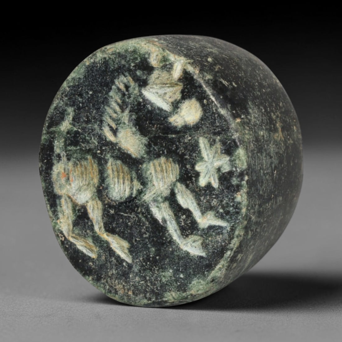 Ancient Sasanian Persian Dark Stone Cylindrical Stamp Seal (224-651 CE), 38ED: This antique dark stone cylindrical stamp seal originates from Ancient Sasanian Persian civilisation, functioning as both a functional implement for making clay impressions and a cherished protective 