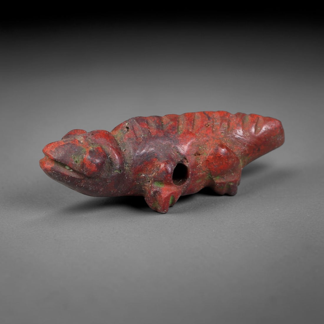 Ancient Sasanian Persian Red Jasper Lizard Amulet Bead (224-651 CE), 48FV: This antique lizard-form amulet bead is carved from natural red jasper, originating from the Sasanian Persian Empire. Reptilian zoomorphic talismans were cherished symbols of renewal, adaptability and