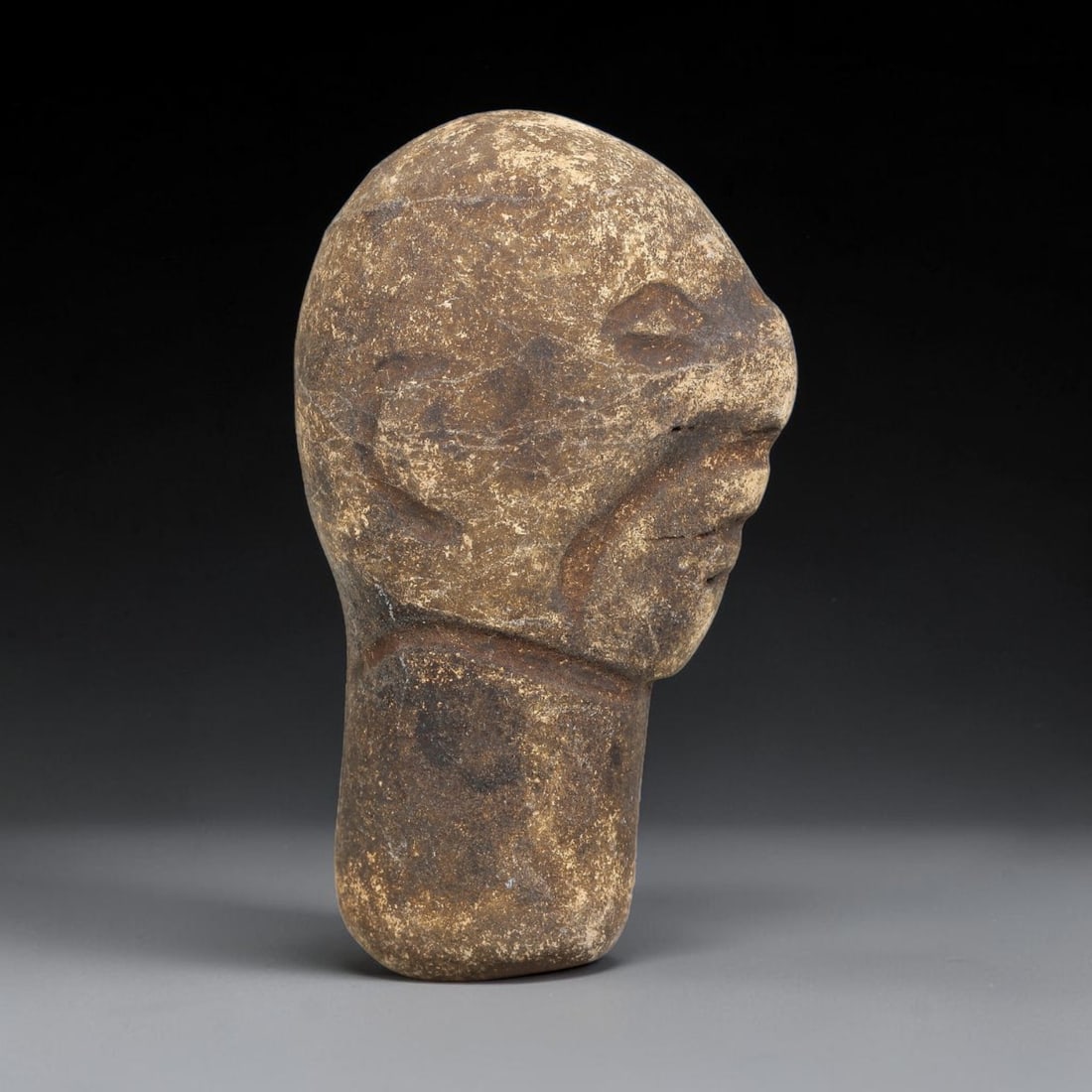 Ancient Medieval Near Eastern Stone Maskette (500-1000 CE), 64EJ: This antique stone maskette originates from medieval Near Eastern cultural tradition, produced for ceremonial and talismanic purposes. The stone shows natural earthy discoloration, surface weathering 