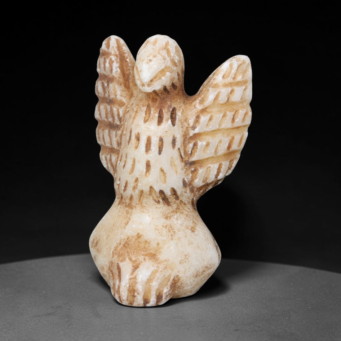 Ancient Sasanian Persian Marble Vulture Amulet Figurine (224-651 CE), 61EQ: This miniature votive amulet is carved from pale marble originating from the Sasanian Persian Empire, sculpted as a perched vulture with fully outstretched wings decorated by incised linear feather de