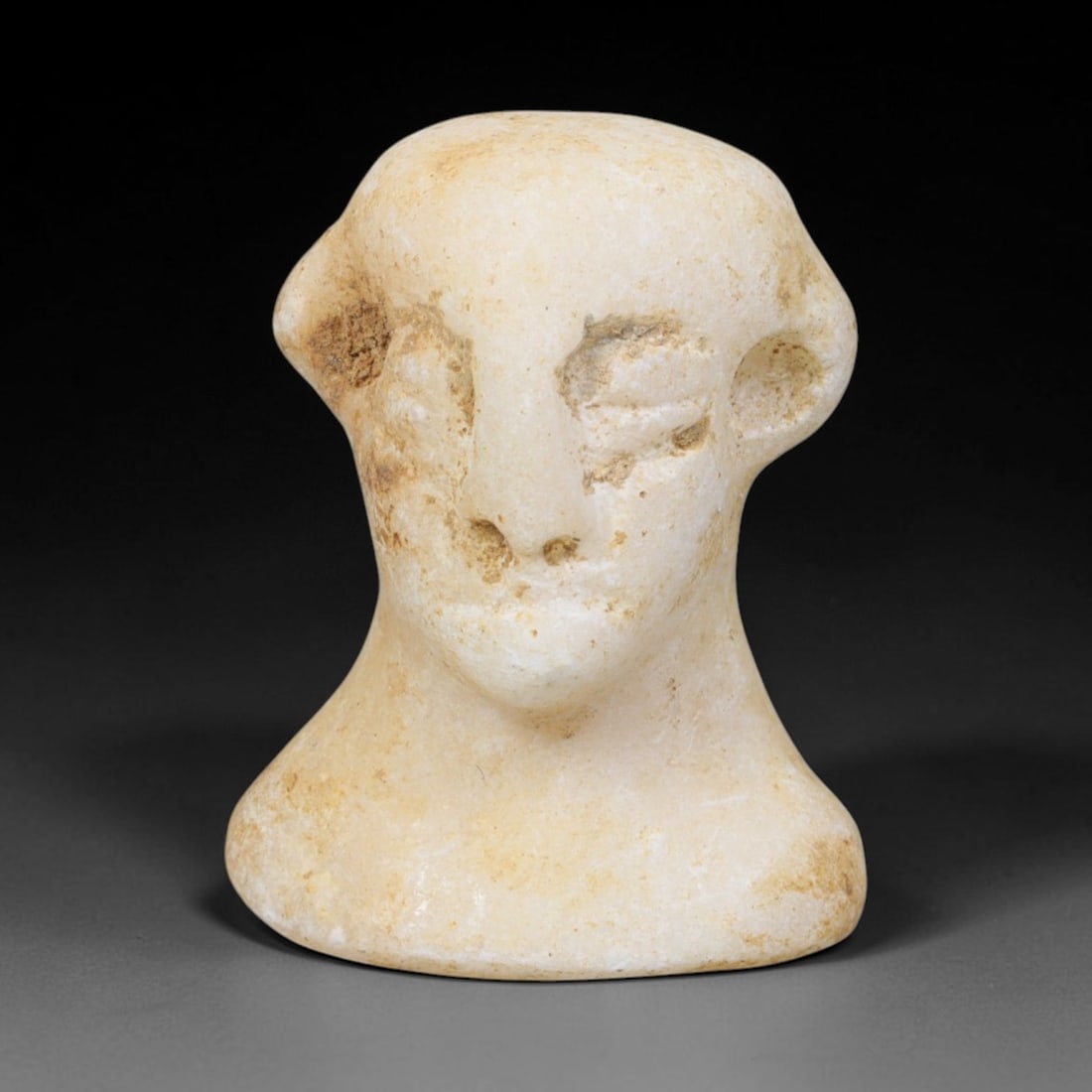 Ancient Bactrian Marble Idol Head (250 BCE-200 CE), 77EQ: This carved pale marble idol head originates from Greco-Bactrian Culture, a significant Silk Road civilization blending Hellenistic and Central Asian artistic traditions. The simplified facial feature