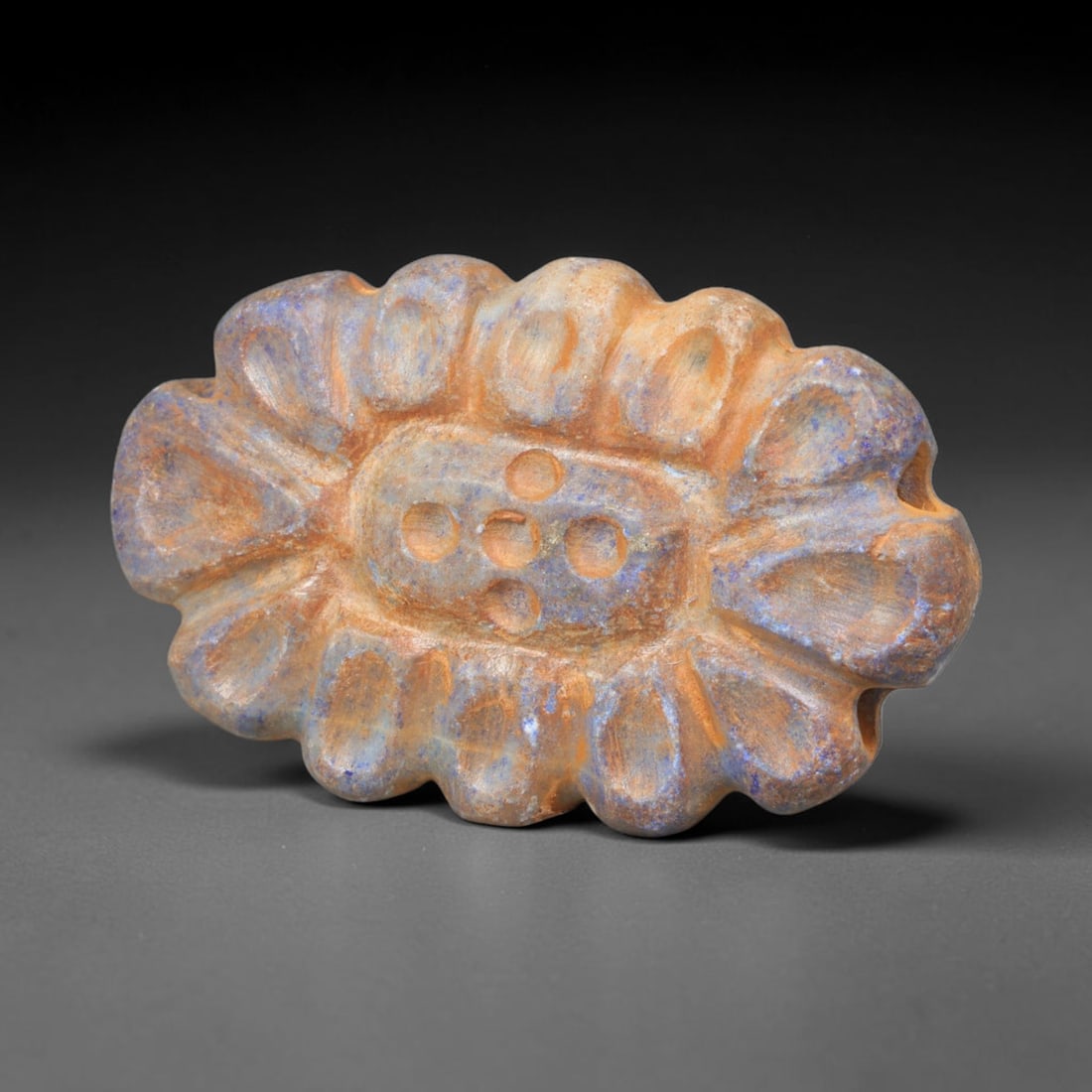 Ancient Achaemenid Persian Lapis Lazuli Rosette Bead (550-330 BCE), 79EQ: This finely carved pendant bead is fashioned from rich lapis lazuli originating from the Achaemenid Persian Empire, decorated with a symmetrical rosette floral motif featuring incised leaf and lattice