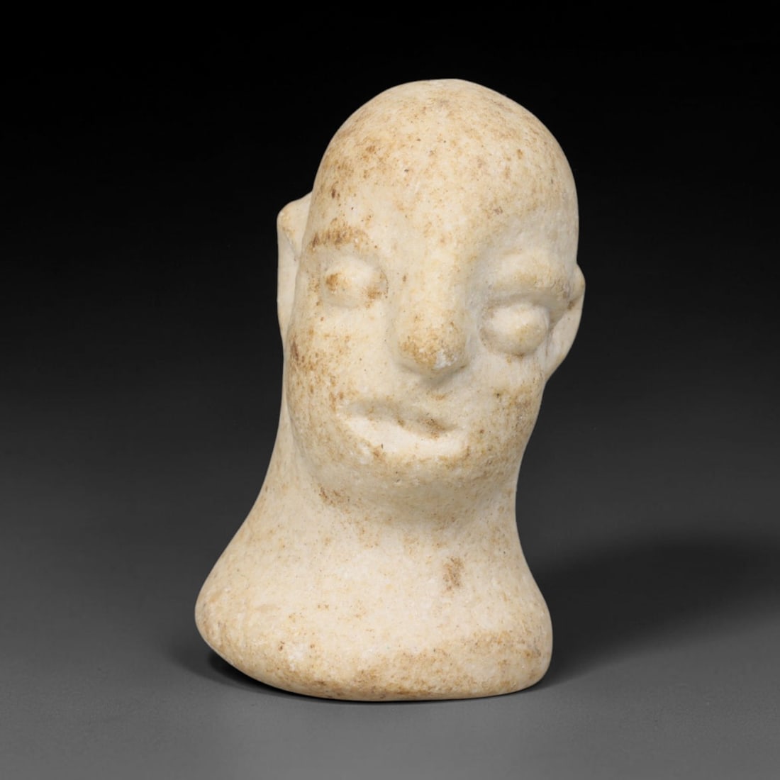 Ancient Bactrian Marble Idol Head (250 BCE-200 CE), 80EQ: This carved pale marble idol head originates from Greco-Bactrian Culture, a significant Silk Road civilization blending Hellenistic and Central Asian artistic traditions. The simplified facial feature