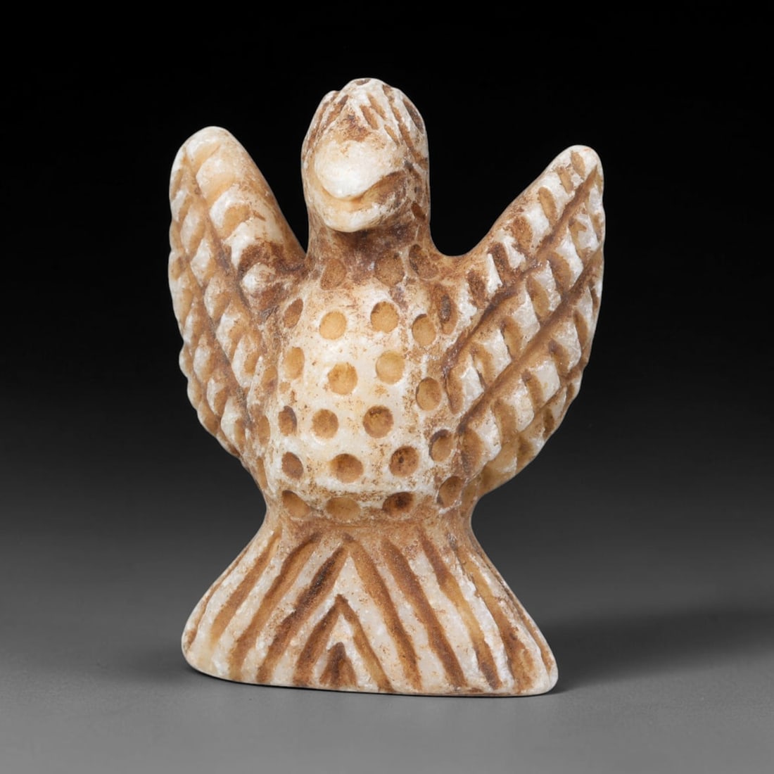 Ancient Sasanian Persian Marble Vulture Amulet Figurine (224-651 CE), 87EQ: This miniature votive amulet is carved from pale marble originating from the Sasanian Persian Empire, sculpted as a perched vulture with fully outstretched wings decorated by incised linear feather de