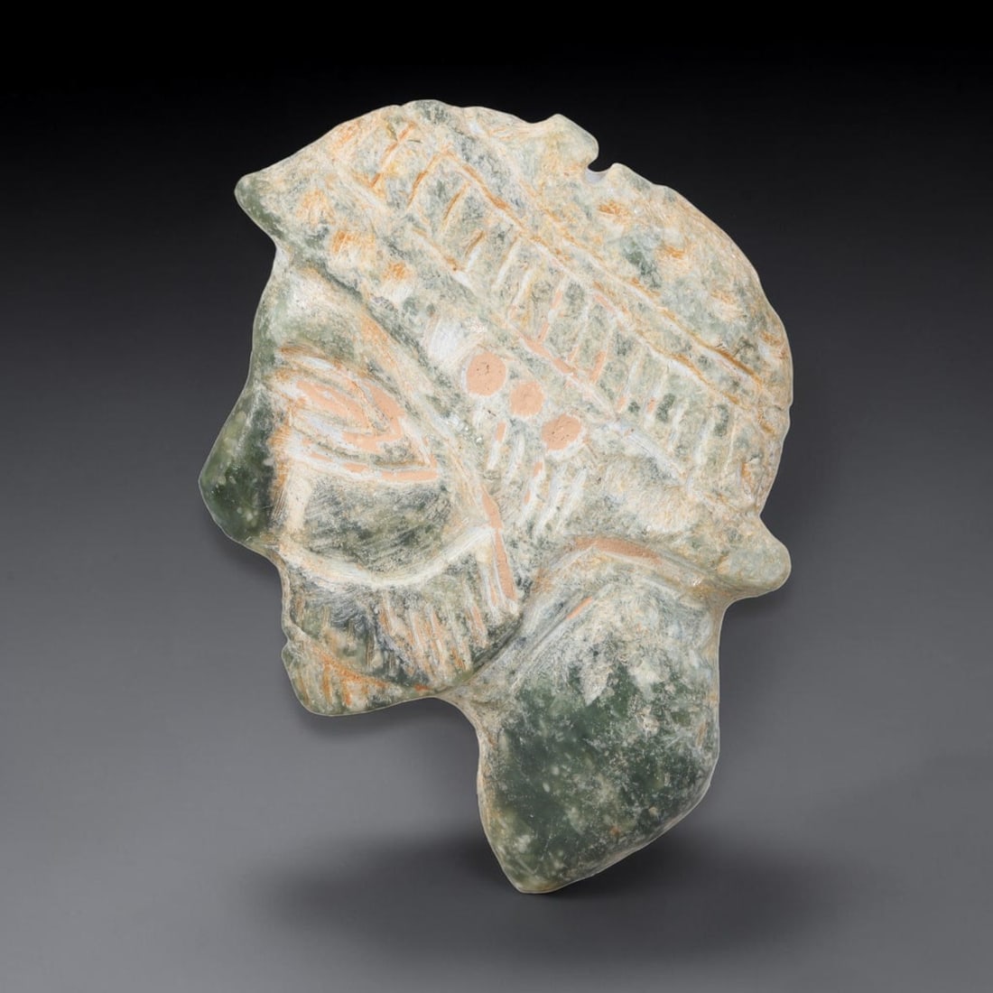 Ancient Sasanian Persian Serpentine Noble Portrait Amulet Plaque (224-651 CE), 3ER: This flat cut amulet plaque is carved from mottled serpentine stone originating from the Sasanian Persian Empire. The plaque features a raised relief profile bust of a bearded noble male figure adorne