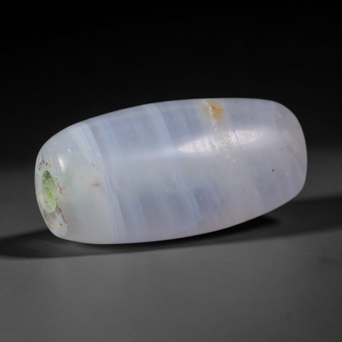 Ancient Parthian Persian Empire Banded Agate Barrel Bead (247 BCE - 224 CE), 35AD: This antique banded agate barrel bead originates from the Parthian Persian Empire, a major power spanning the Iranian plateau that developed refined agate bead workshops supplying ritual talismans and