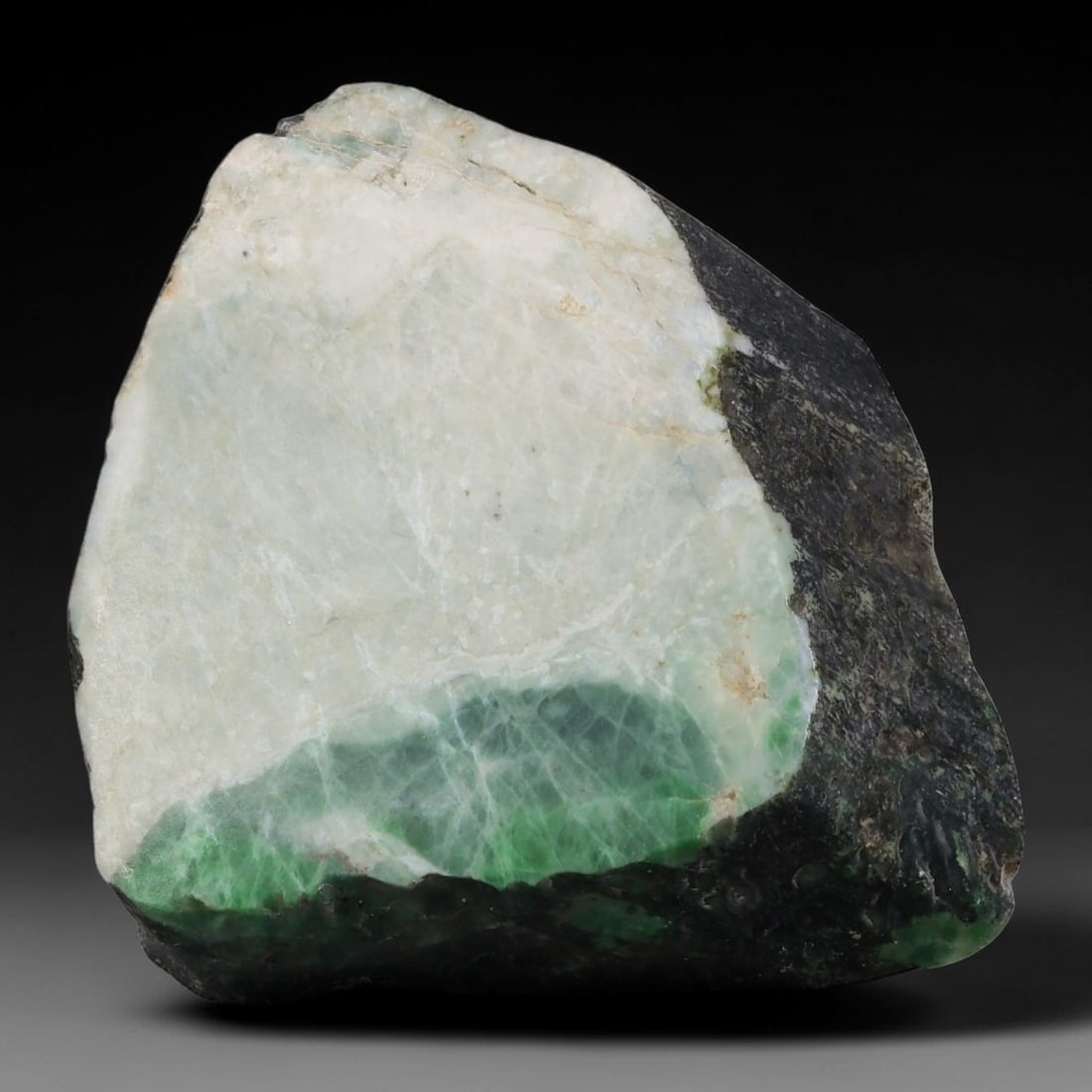 267ct Natural Type A Burmese Jadeite Jade Sliced Rough, 19AZ: This specimen is a sliced rough block of natural Type A Burmese jadeite jade. The interior displays natural colour zoning with visible mineral veining and crystalline patterns typical of unprocessed j