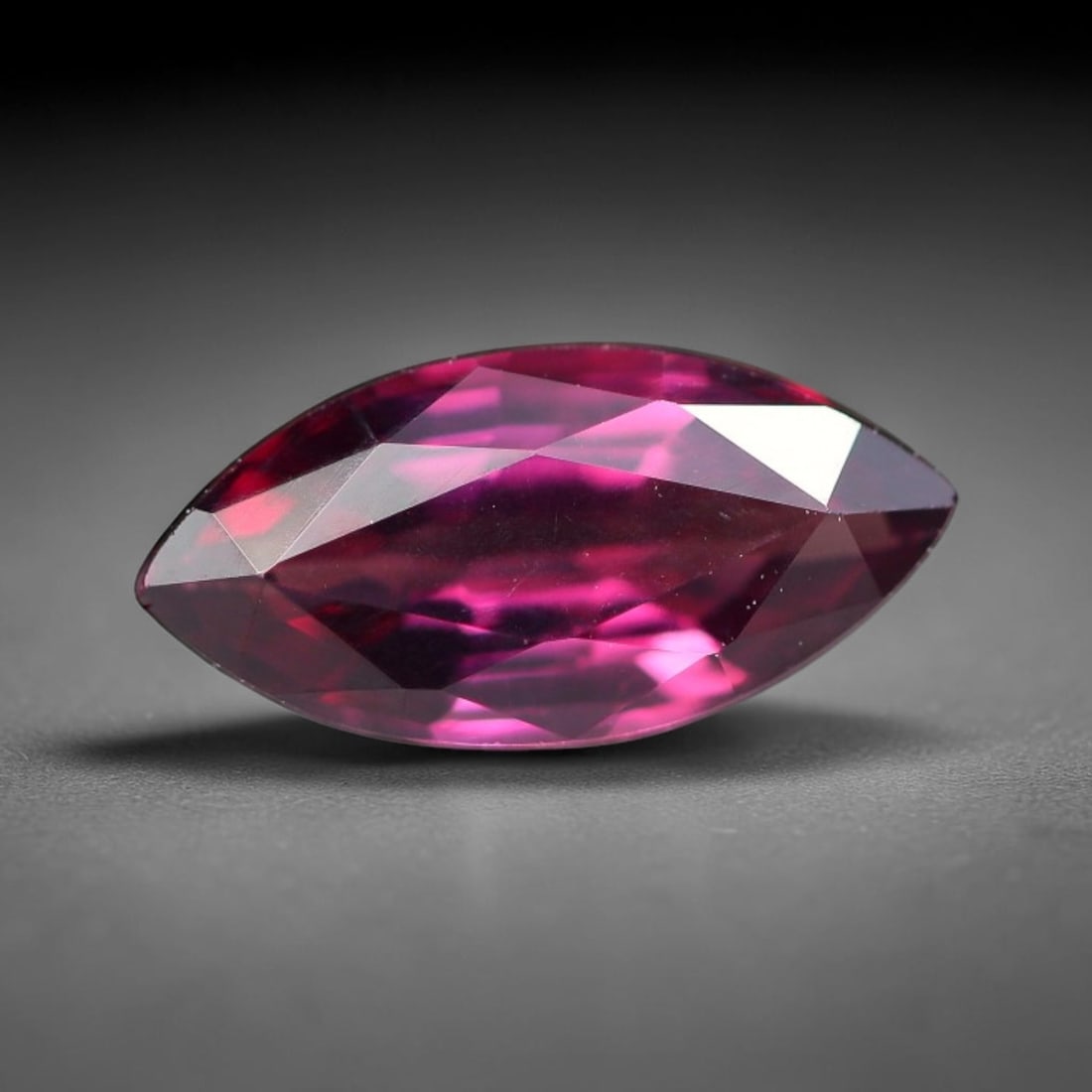 1.04ct Natural Tanzanian Rhodolite Grape Garnet Faceted Loose Gemstone, 1BE: This expertly faceted grape garnet, a scarce saturated purple-magenta rhodolite variant, features transparent crystal structure dotted with faint microscopic mineral specks within its precisely cut re