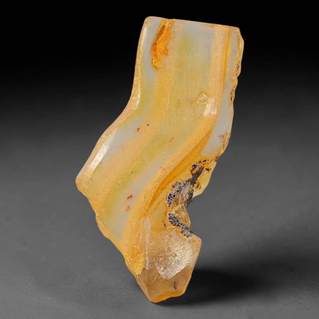17.68ct Natural Baltic Polished Loose Freeform Amber Gemstone, 50EB: This smoothly polished freeform amber piece carries warm translucent organic clarity with fine natural fossil flecks and tiny mineral inclusions suspended throughout its 43x25mm flowing unstructured s