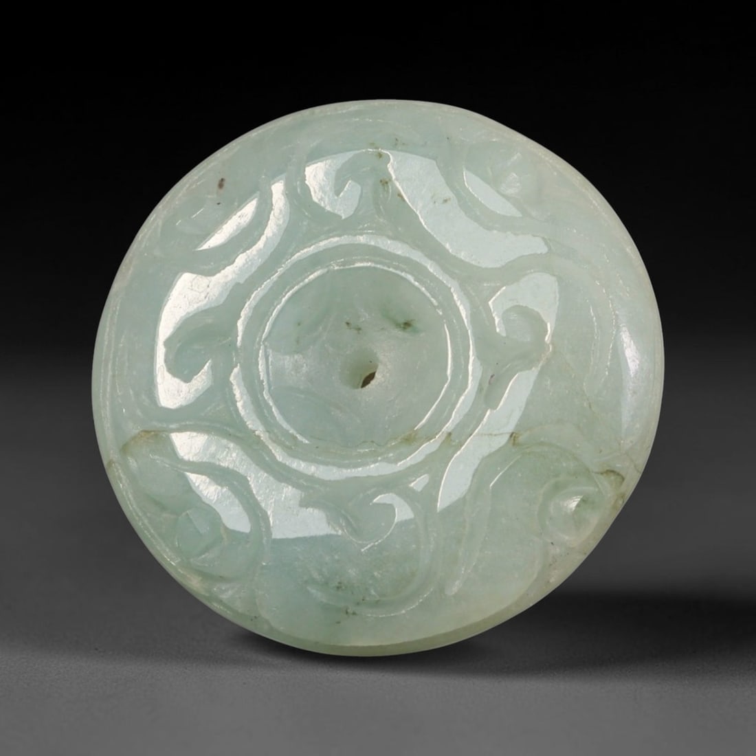 Natural Burmese Type A Jadeite Jade Carved Disc Pendant, 32BP: Artisan hand-carved untreated Burmese Type A jadeite jade circular disc pendant with a 26 mm diameter. The surface is adorned with detailed traditional relief carving finished with a smooth polished s