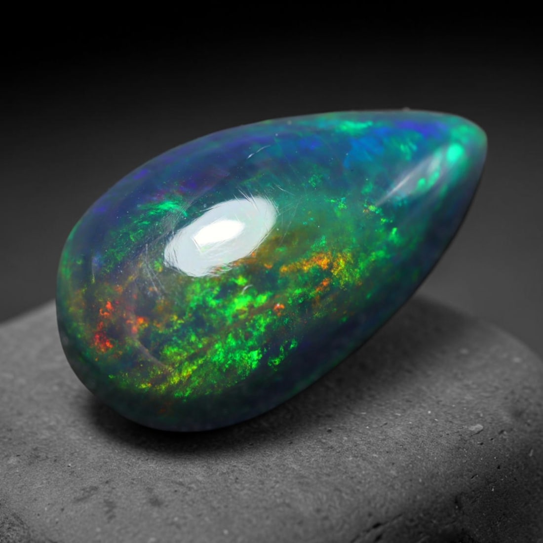 2.70ct Natural Ethiopian Welo Black Smoked Opal Cabochon Loose Gemstone, 40BY: This fully polished Ethiopian Welo opal features a dark smoked base with vivid, sweeping play-of-color shifting across its glossy dome surface, measured at 13x8x5mm. The black smoke treatment deepens 