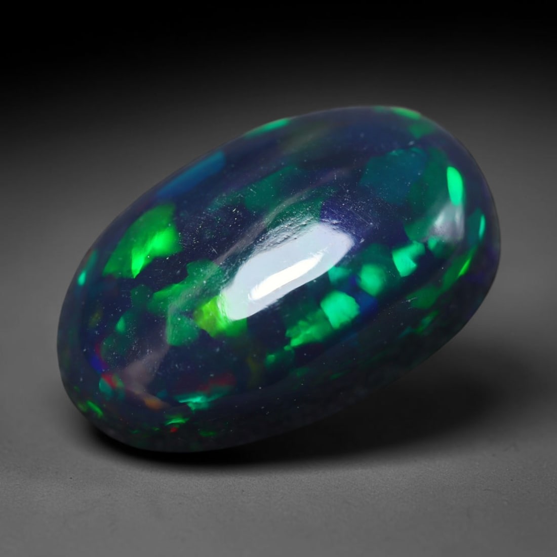 3.18ct Natural Ethiopian Welo Black Smoked Opal Cabochon Loose Gemstone, 37BY: This fully polished Ethiopian Welo opal features a dark smoked base with vivid, sweeping play-of-color shifting across its glossy dome surface, measured at 13x8x7mm. The black smoke treatment deepens 