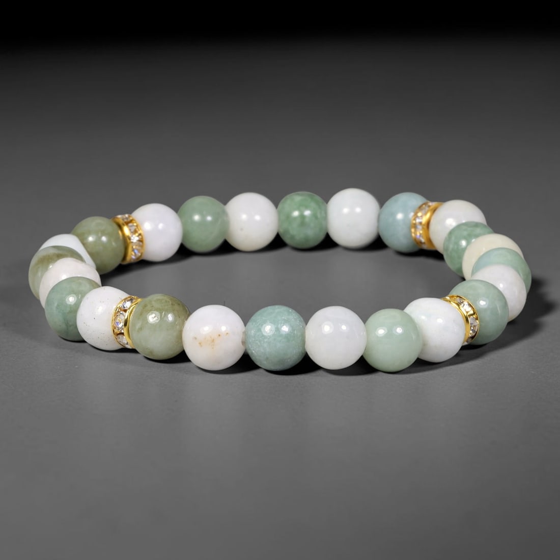 Natural Burmese Type A Jadeite Jade Beaded Bracelet, 28EP: Polished natural jadeite jade round beads complemented by decorative crystal spacer accents. Uniform 8mm beads form a flexible wearable strand. A timeless gemstone bracelet suitable for daily styling,