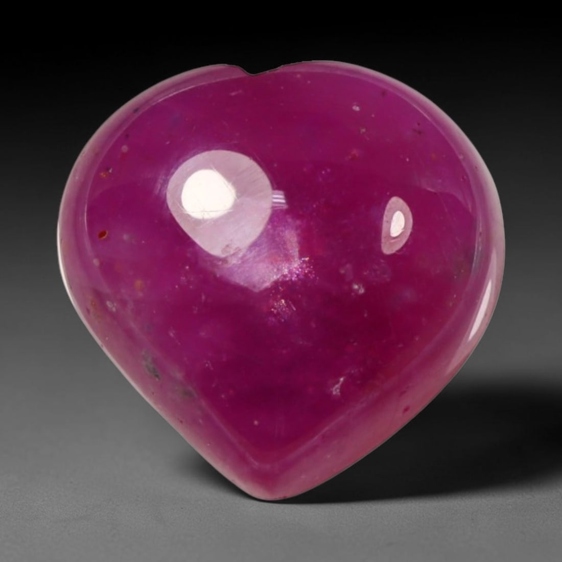 5.61ct Natural Mozambique Hot Pink Ruby Loose Gemstone, 68BP: This heart shaped Mozambique ruby cabochon measures 10.2x9.7x5.1mm, showcasing a vivid saturated hot pink body paired with stunning natural hexagonal crystal growth banding that forms a distinct geome