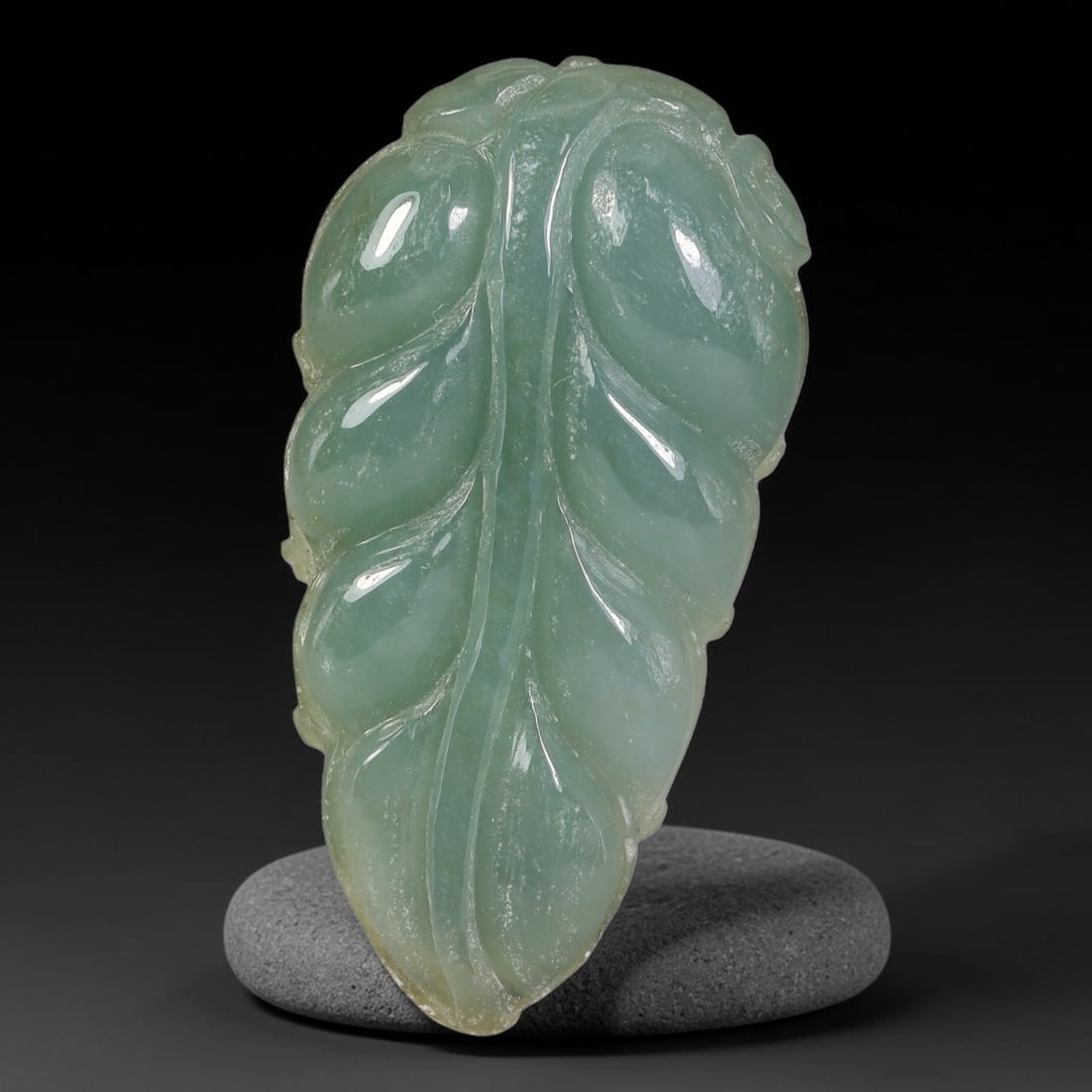 Natural Burmese Type A Hand Carved Jadeite Jade Leaf Pendant, 87AT: Exquisitely hand-sculpted natural Burmese Type A jadeite jade pendant shaped as a full natural leaf motif, measuring 34 x 18 mm. Fine polished relief carving details the central vein and layered leaf 