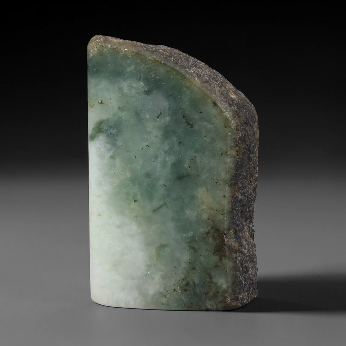 270ct Natural Type A Burmese Jadeite Jade Sliced Rough, 62FD: This specimen is a sliced rough block of natural Type A Burmese jadeite jade. The interior displays natural colour zoning with visible mineral veining and crystalline patterns typical of unprocessed j