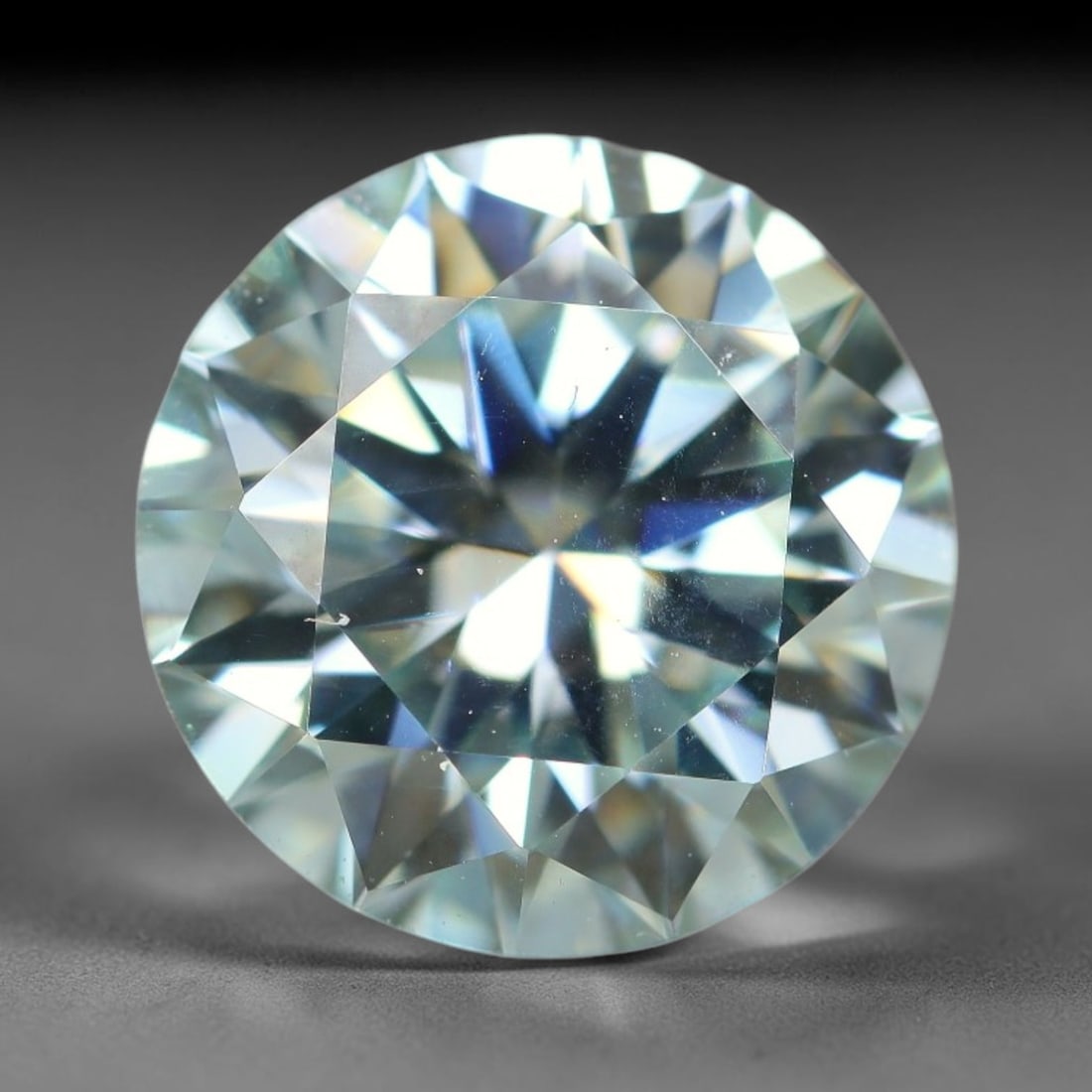 2.50 Carats Natural Cool White Moissanite Loose Gemstone, 2FL: This cool white moissanite holds dimension measurements of 9x5.3mm, delivering exceptional light dispersion that generates vivid rainbow sparkle across its fully transparent body, with faint microscop