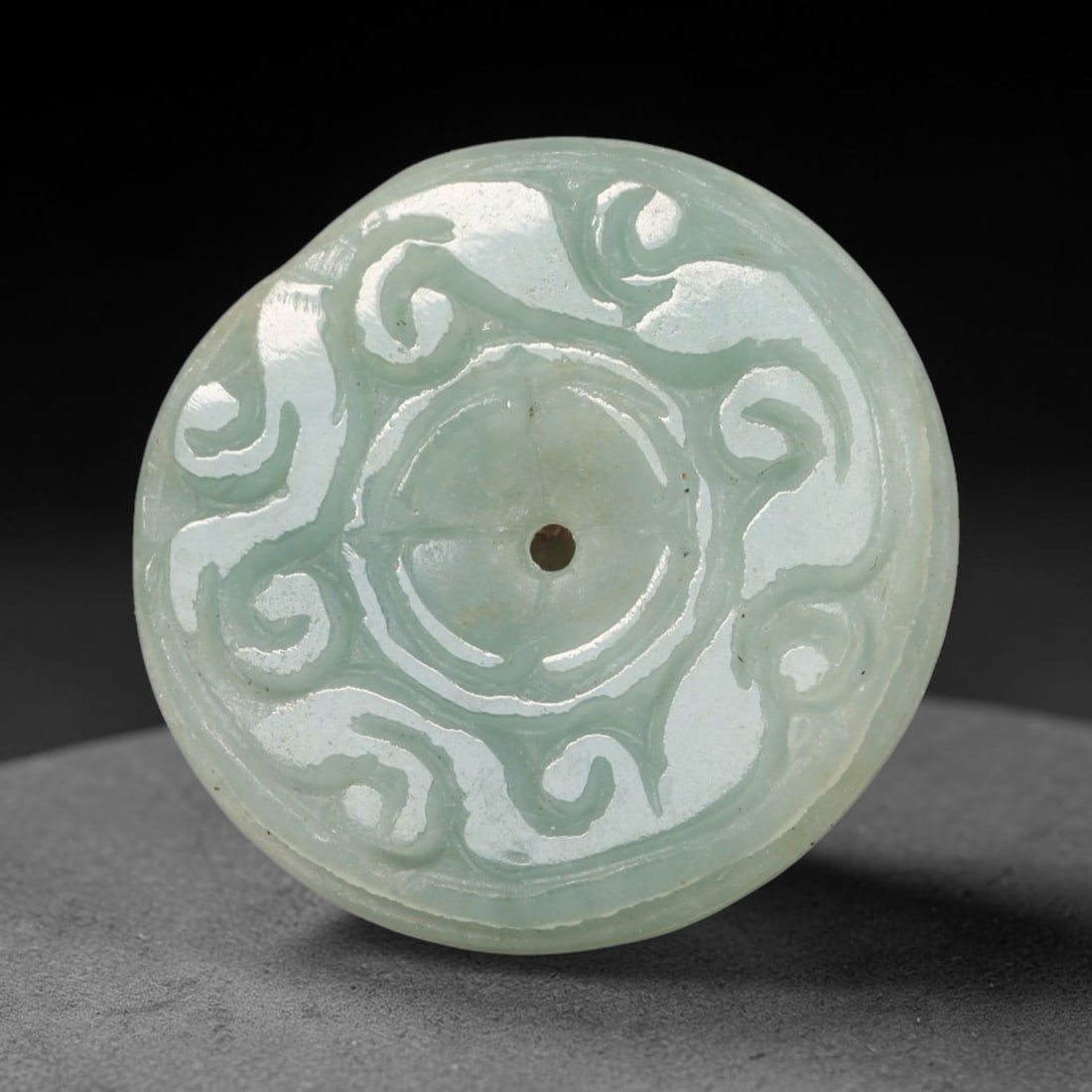 Natural Burmese Type A Jadeite Jade Carved Disc Pendant, 52BP: Artisan hand-carved untreated Burmese Type A jadeite jade circular disc pendant with a 26 mm diameter. The surface is adorned with detailed traditional relief carving finished with a smooth polished s