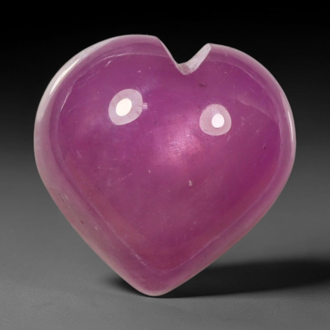7.55ct Natural Mozambique Hot Pink Ruby Loose Gemstone, 73BP: This heart shaped Mozambique ruby cabochon measures 10.6x10.4x6.3mm, showcasing a vivid saturated hot pink body paired with stunning natural hexagonal crystal growth banding that forms a distinct geom