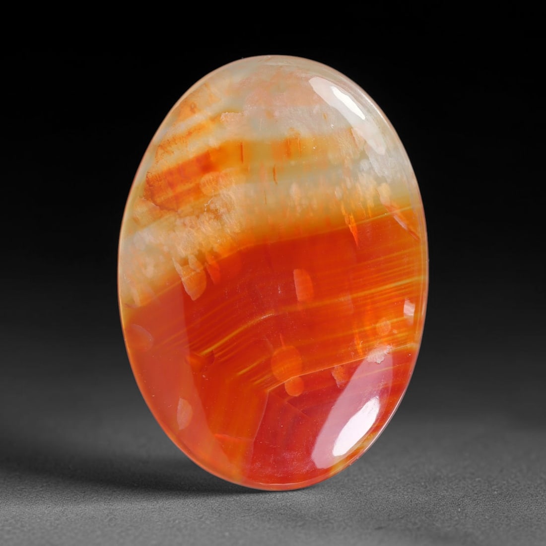 24.10ct Natural Banded Agate Cabochon Loose Gemstone, 6EQ: This natural banded agate cabochon features striking layered warm orange and creamy white banding across its smooth polished surface. Dimensions measure 34x24x3mm, this well-finished cabochon presents