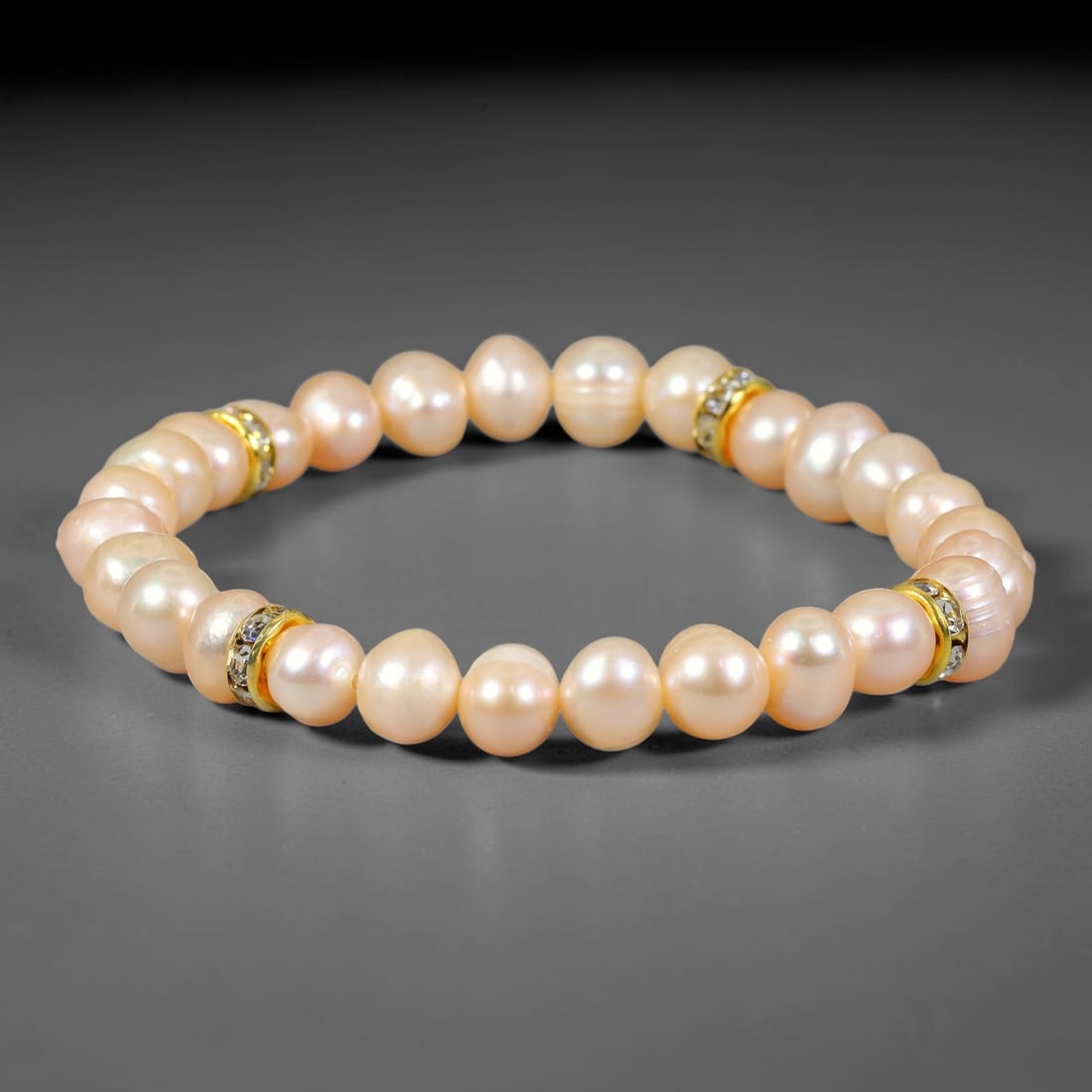 Natural Freshwater Pearl Stretch Bracelet with Gold Tone Crystal Spacers, 93FV: Beautiful stretch bracelet made with 7mm natural freshwater pearls paired with polished gold-toned crystal spacer accents. These organic pearls carry gentle natural luster, strung on flexible elastic 