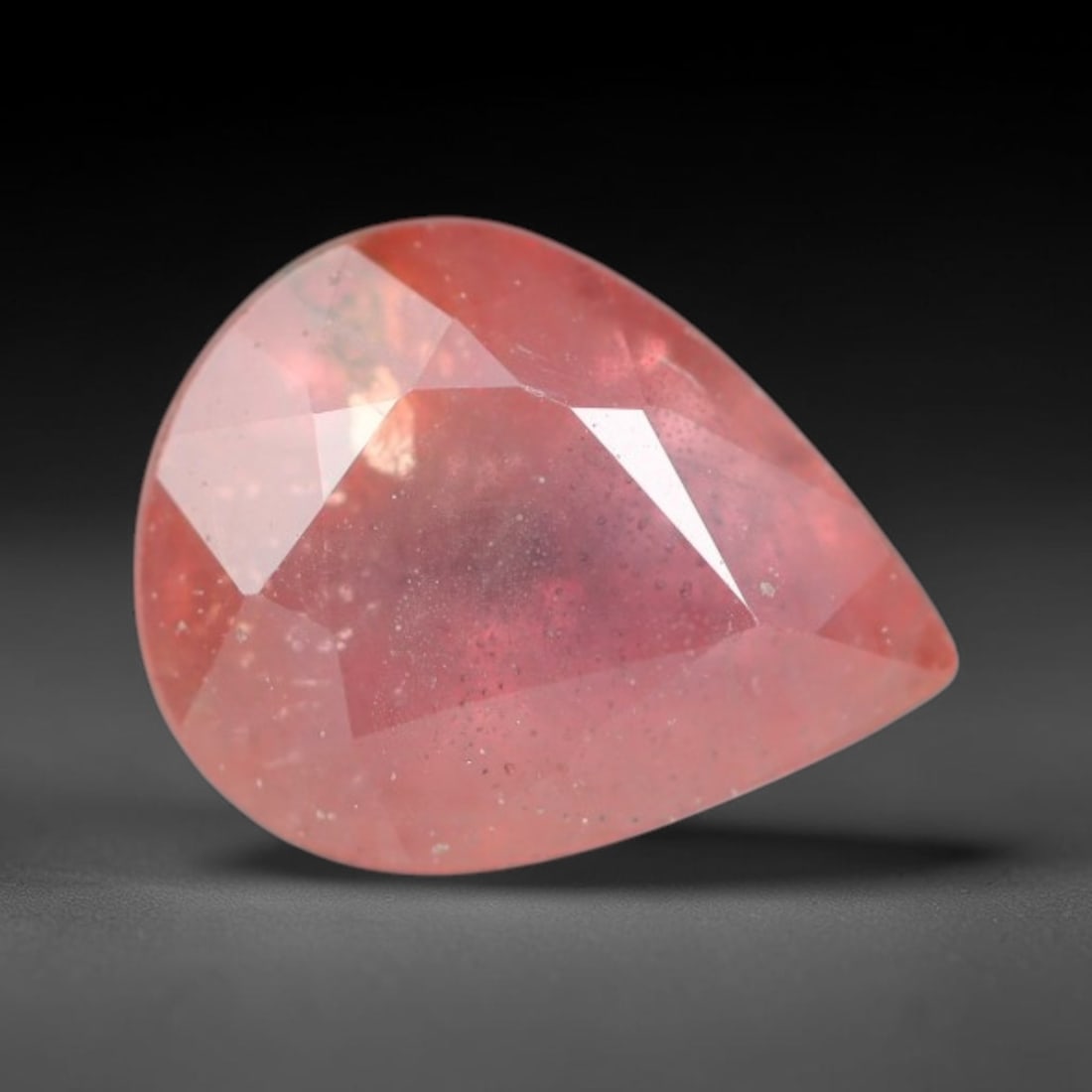 0.94ct Natural Sri Lankan Padparadscha Sapphire Loose Gemstone, 58BC: This fully polished Padparadscha sapphire carries warm blended peach-pink and soft orange body saturation, with subtle microscopic mineral flecks dispersed within its crystalline interior across its c