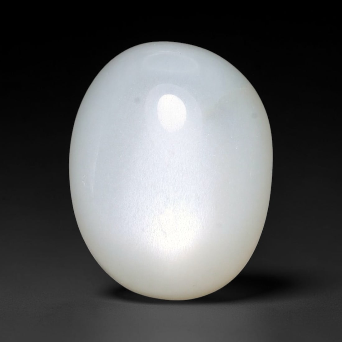 14.07ct Natural Ceylon White Moonstone Cabochon Loose Gemstone, 8FY: This natural Ceylon moonstone cabochon carries a milky white body showcasing classic adularescence. Fine mineral inclusions are visible within the gem. Dimensions measure 16x12x8mm, mined in Sri Lanka