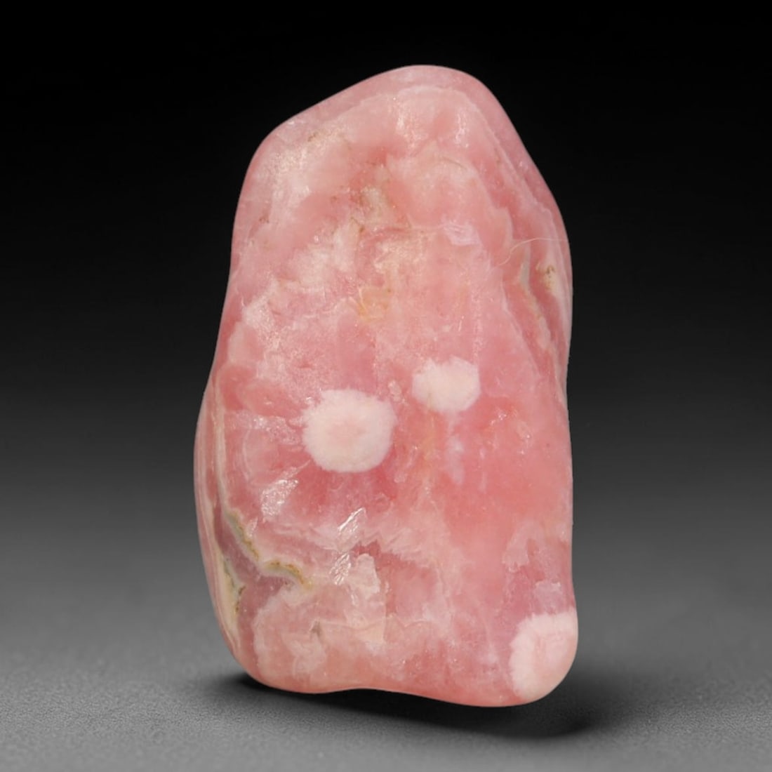 43ct Natural Argentine Rhodochrosite Tumbled Banded Rough Specimen, 2FD: This smooth rounded rough specimen is natural banded rhodochrosite sourced from Argentina's Capillitas mining district, displaying characteristic layered concentric banding of soft blush pink, creamy 