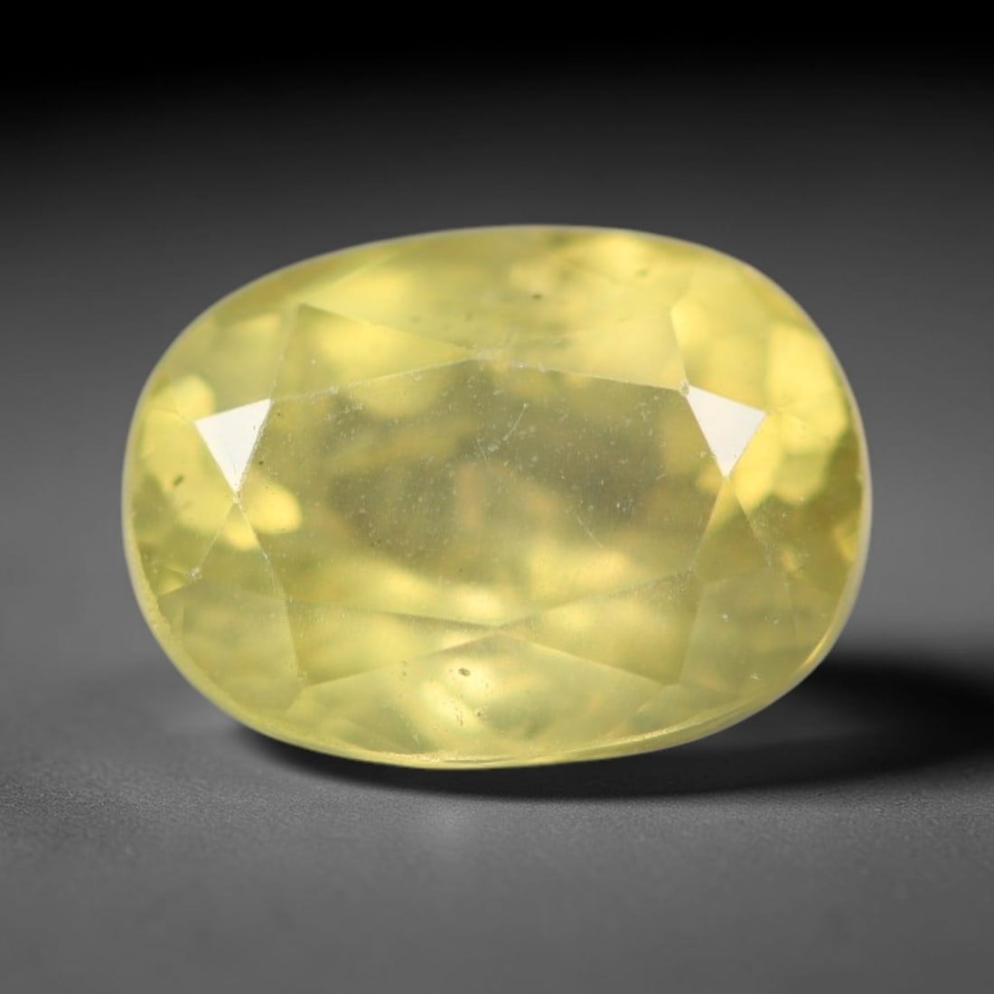 1.46ct Natural Mexican Lemon Yellow Faceted Apatite Loose Gemstone, 38BC: This expertly faceted yellow apatite holds translucent pale lemon yellow crystal structure with faint tiny internal mineral specks and subtle fine linear markings visible beneath its precisely polishe
