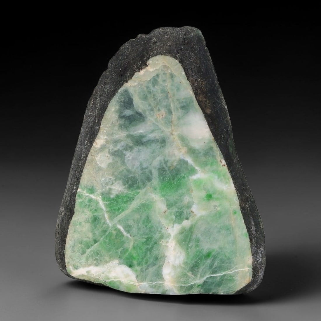 238ct Natural Type A Burmese Jadeite Jade Sliced Rough, 98AY: This specimen is a sliced rough block of natural Type A Burmese jadeite jade. The interior displays natural colour zoning with visible mineral veining and crystalline patterns typical of unprocessed j