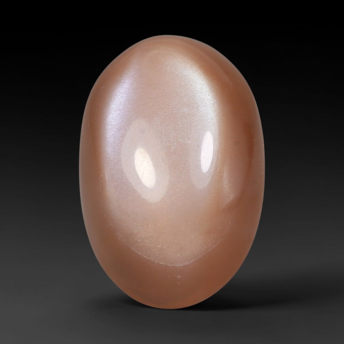 19.71 Carats Natural Ceylon Warm Peach Moonstone Loose Gemstone, 90FE: This natural Ceylon moonstone has dimension measurements of 22.1x14.6x3.8mm, showcasing a smooth warm peach base tone paired with subtle soft adularescent sheen that glides gently across the polished 